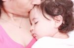 Mother Kissing Her Daughter Stock Photo