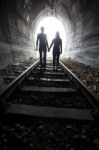 Couple Walking Together Through A Railway Tunnel Stock Photo