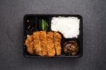 Japanese Food Tonkatsu Rice And Vegetable Take Away On Table Background Stock Photo