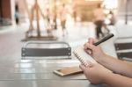 Woman Hand Writing On Notepad Stock Photo