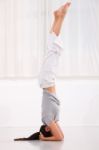 Young Woman Doing Yoga Headstand Pose Stock Photo