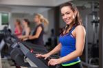 Beautiful Brunette On A Treadmill Stock Photo