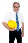 Smiling Experienced Architect Posing With Safety Helmet Stock Photo