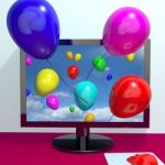 Computer with flying balloons Stock Photo