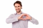 Man Making Heart Symbol With Hands Stock Photo