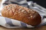 Dark Multigrain Bread Whole Grain Fresh Baked On Rustic Closeup Stock Photo