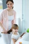 Mother Combing Her Daughter In The Bathroom Stock Photo