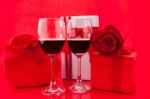 St Valentine's Setting With Present And Red Wine Stock Photo