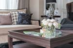 Glass Vase Of Flower On Wooden Table In Living Room Stock Photo