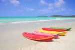 Multiple Color Kayaks Rest On Tropical Beach Stock Photo