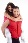 Couple Riding Piggy Back Stock Photo