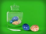 Easter Egg In Glass Jar On Green Background Stock Photo