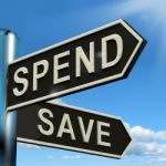 Spend Or Save Signpost Stock Photo