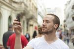 male Photographer With Mobile Phone Stock Photo