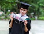 Graduation Asian Girls With Congratulation In Thai Wording Stock Photo