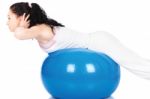 Woman Stretching On The Blue Ball Stock Photo