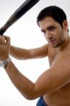 Side Pose Of Man With Stick Stock Photo