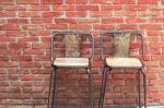 Outdoor Steel Chair On Red Brick Wall Stock Photo