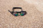 Glasses For Swimming On A Cement Floor With Small Stone Near Swi Stock Photo