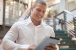 Man With Tablet Computer In Modern Business Building Stock Photo