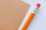 Pencil And Brown Note Paper Stock Photo