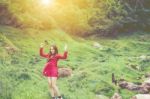 Summer Portrait Of Young  Women Enjoying Nature  In Tight Fitting Red Dress Summer Vacation,sunny,having Fun, Positive Mood,romantic, Against Background Of Summer Green Park, Green Leaves Stay Outdoor Stock Photo