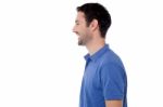 Side View Posing Of Smiling Guy Stock Photo