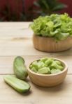 Fresh Cucumber And Green Lettuce In Wooden Bowl Stock Photo