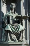 A Statue Of A Woman Holding The Books Of Thomas Aquinas Stock Photo