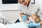 Lady Stomatologist Checking Childs Teeth Stock Photo