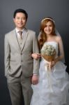 Young Asian Groom And Bride Posing In Studio For Pre Wedding Sho Stock Photo