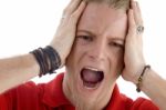 Male Holding His Head And Shouting Stock Photo