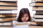 Asian Girl In Pile Of Books Stock Photo