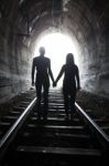 Couple Walking Together Through A Railway Tunnel Stock Photo