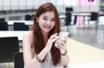 Portrait Of Thai Adult Beautiful Girl Using Her Smart Phone And Smile Stock Photo