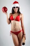 Sexy Santa Girl In Bikini Holding A Christmas Ball Stock Photo