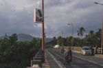 Road Bridge Into Green Land Full Of Palm Trees Stock Photo