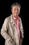 Portrait Close Up Smiling Happiness Face Of 59s Years Old Asian Man With Studio Light Against Black Background Stock Photo