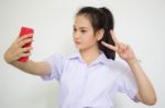 Portrait Of Thai High School Student Uniform Beautiful Girl Using Her Smart Phone Selfie Stock Photo