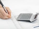 Bookkeeping With Calculator Stock Photo