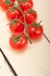 Fresh Cherry Tomatoes On A Cluster Stock Photo