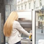 Woman Using Bank ATM Stock Photo