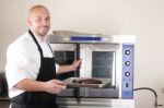 Happy Chef Taking His Freshly Baked Rib-eye Steak Stock Photo