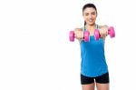 Pretty Woman Lifting Dumbbells Stock Photo