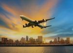 Passenger Plane Flying Above Urban Scene Use For Convenience Air Stock Photo