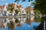 View Along A Canal In Bruges West Flanders In Belgium Stock Photo