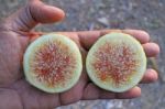 Half Sections Of Fig Fruit  On Hand Stock Photo