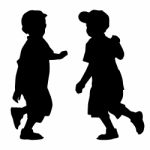 Silhouettes Of Two Little Boys Stock Photo