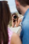 Young Woman Taking Pictures Of A Couple In The City Stock Photo