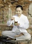 Woman Playing A Tibetan Bowl, Traditionally Used To Aid Meditati Stock Photo